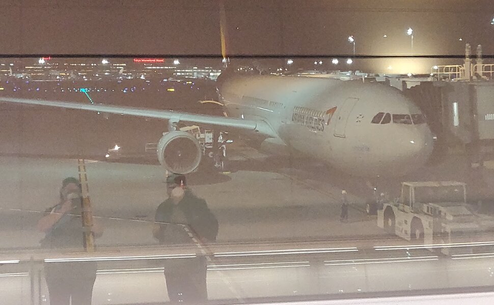 Our plane landed in Tokyo International Airport (Haneda) looking huge. It's dark and James and I are visible in the window's reflection.