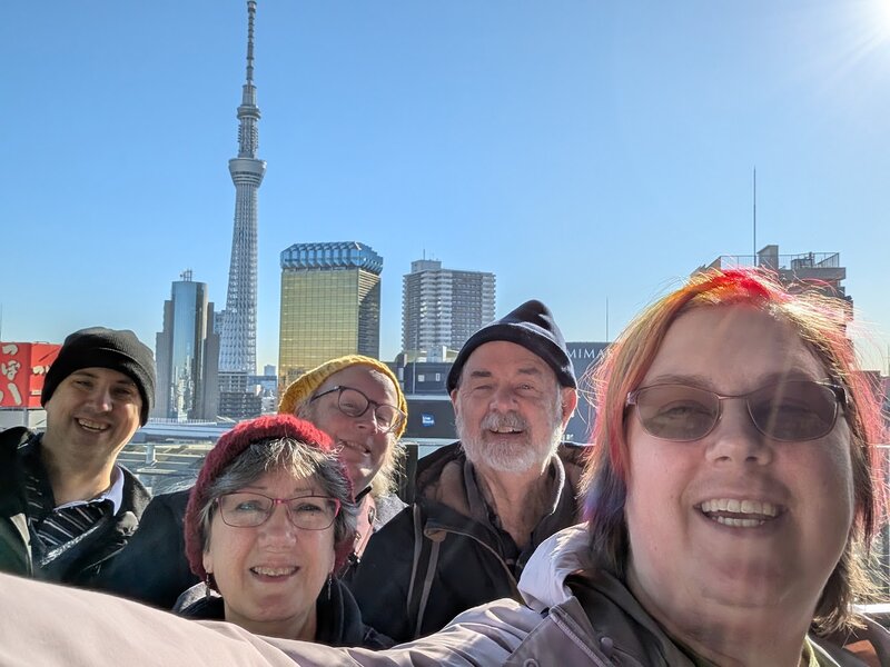 Selfie of Andrew, Mom, James, Dad and me with the Skytree in the background on a sunny morning