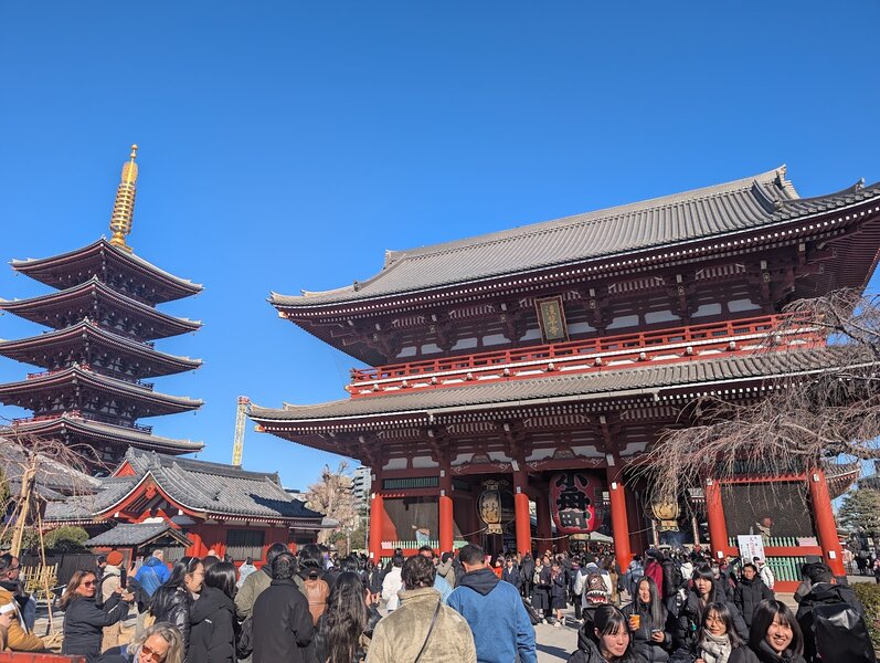 Wide shot of the pagoda and temple, showing off both the lovely curved roofs with vermilion accents and how busy the plaza in front if it is.